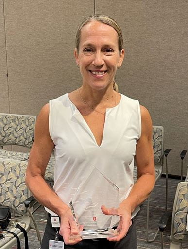 Julia Bishop, MD, holding her award