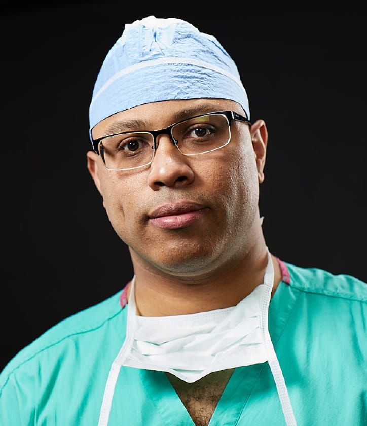 Dr. Sylvester Black wearing green surgical scrubs