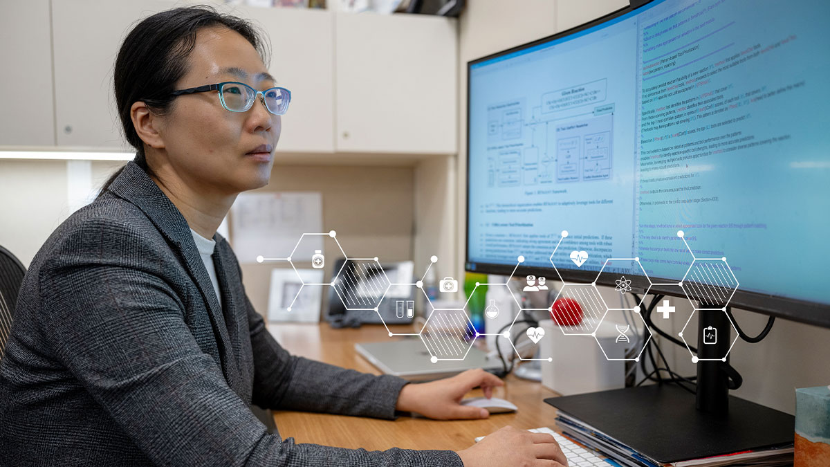 Dr. Ning looking at computer reviewing AI resources.