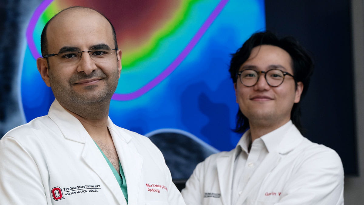 Mina Makary and Gavin Wu standing in front of scans.
