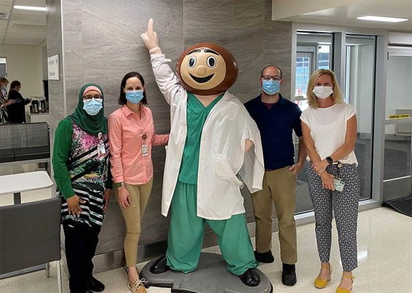 Members of Bioethics staff with statue of Brutus