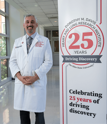 Tom Hund with 25th Anniversary Sign