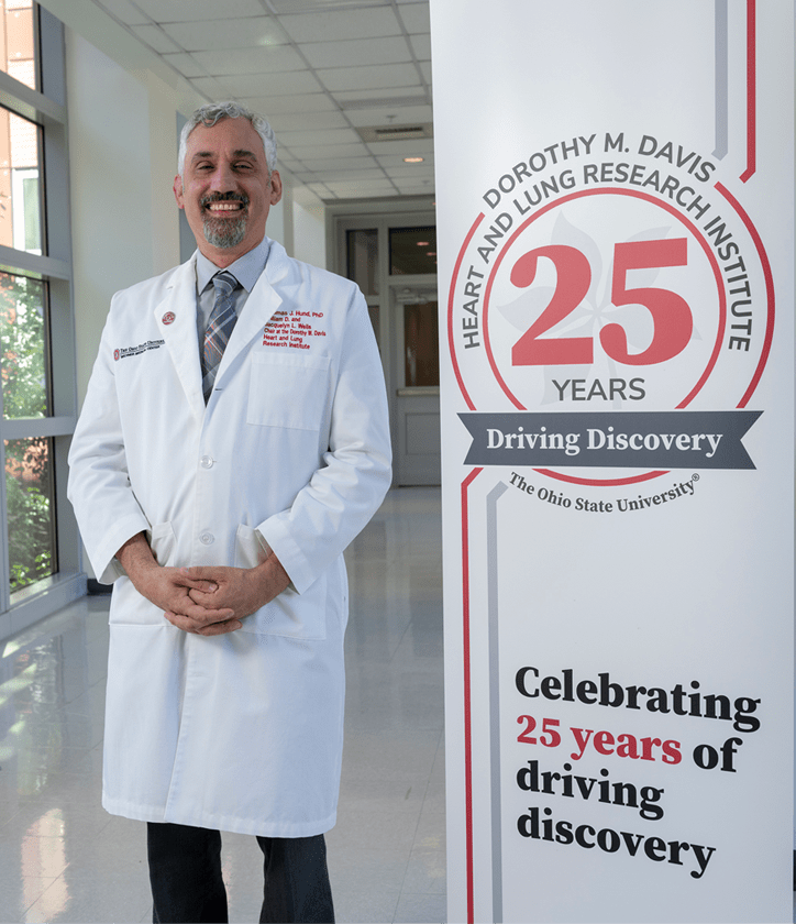Tom Hund with 25th Anniversary Sign