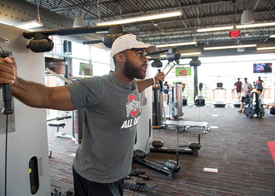 Man lifting weights in Ohio State gym