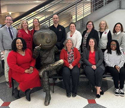 Office of Student Life department poses with Brutus statue.