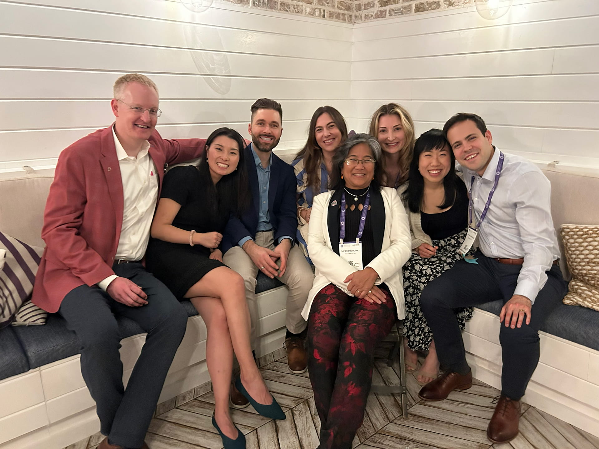 group sitting down and smiling