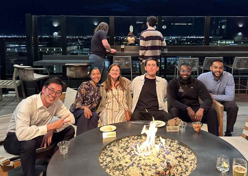 Alumni socializing around a firepit