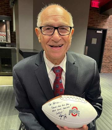Holding autographed OSU football