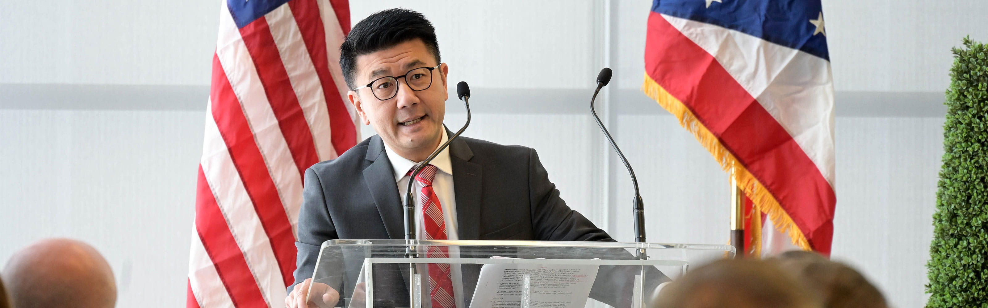 Dr. Phan giving  a speech behind a podium.