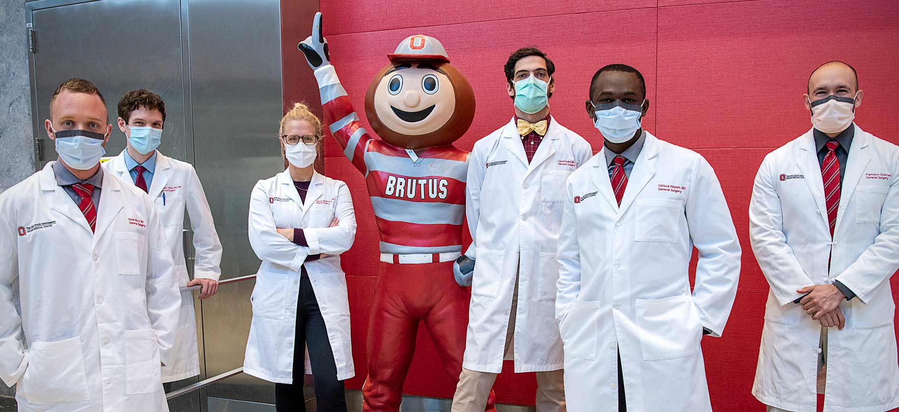 Surgery residents in masks with Brutus Buckeye