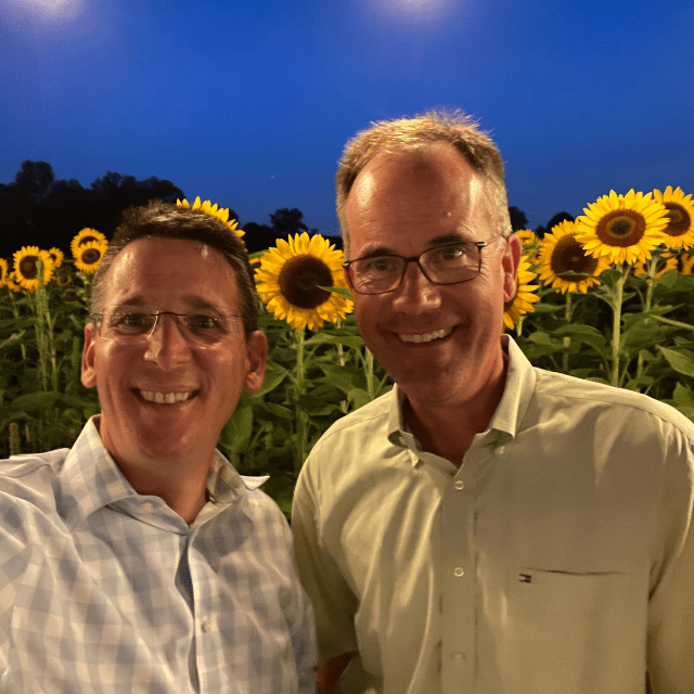 Dr. Pawlik and Bob, a pancreatic cancer survivor, standing in a field of sunflowers