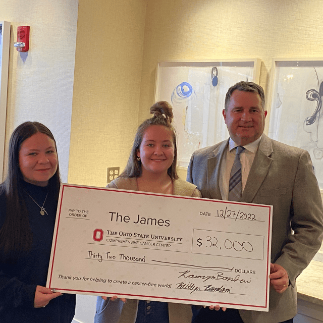 Kamryn and Kaitlyn Bondoni present their donation of $32,000 to Dr. Matthew Kalady, director of the Department of Surgery’s Division of Colon and Rectal Surgery