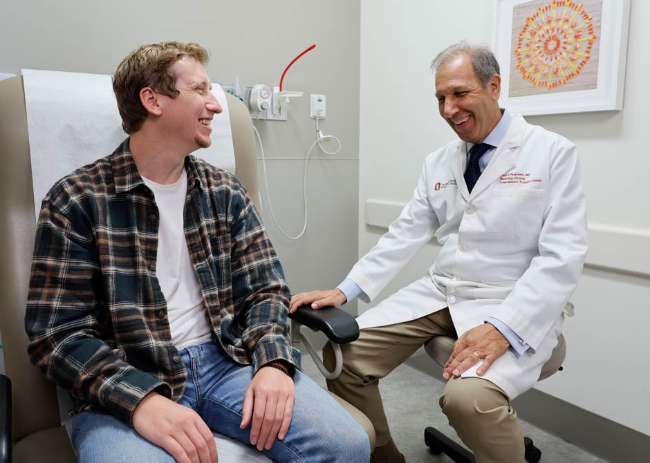 patient and doctor smiling in exam room