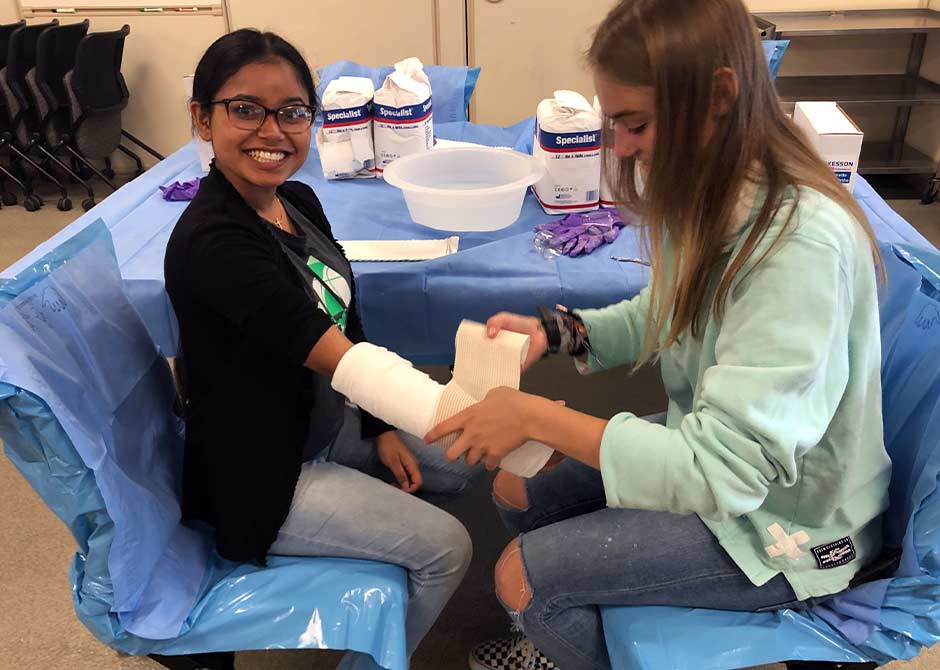 MD Camp participants learning how to wrap a broken arm