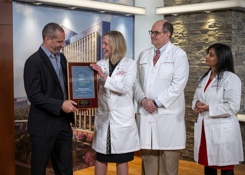 Dean Bradford presenting a faculty member with a faculty recognition award 