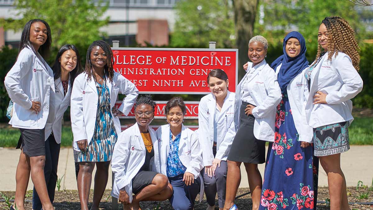 Ohio State medical students students in front of College of Medicine sign