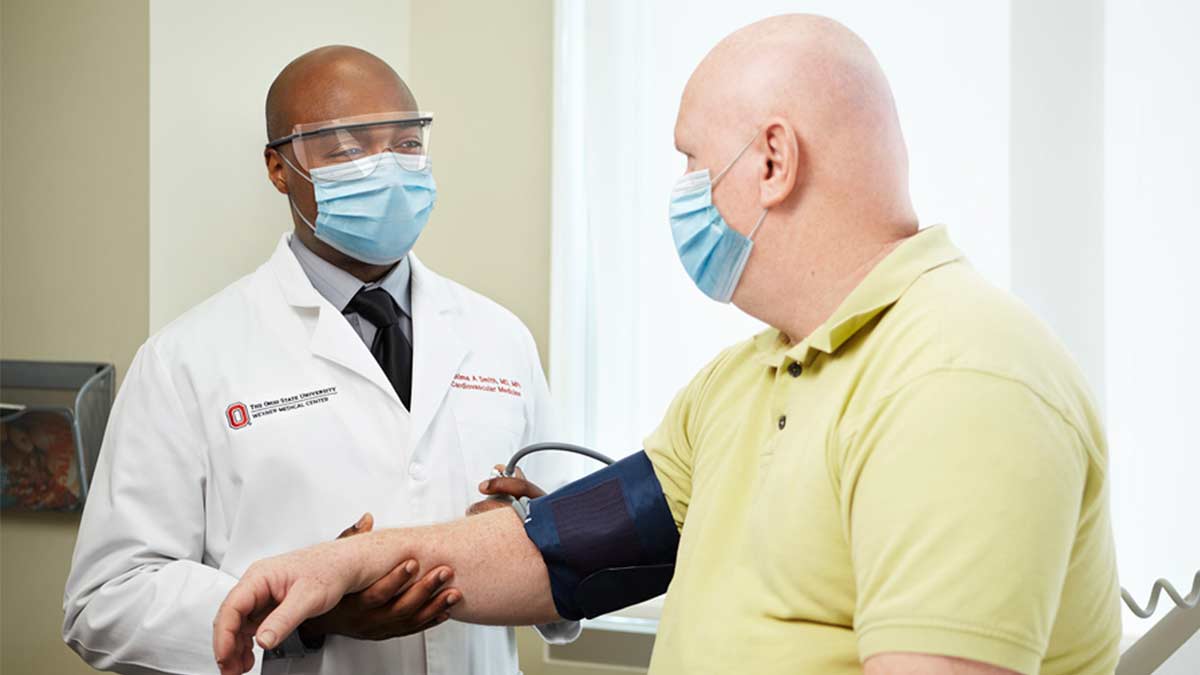 Doctor taking patient's blood pressue