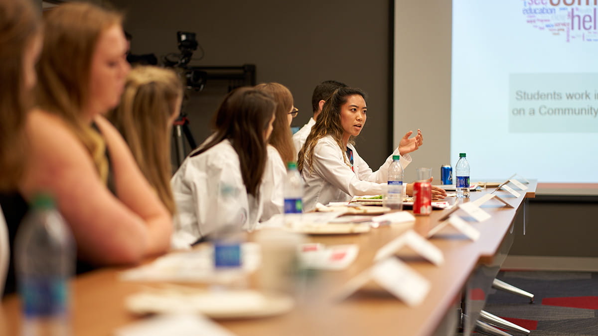 Student talking at an event