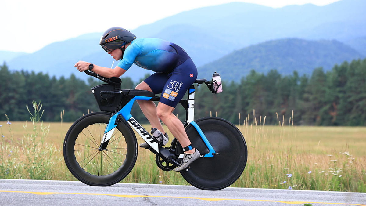 A person riding a bike up the hill