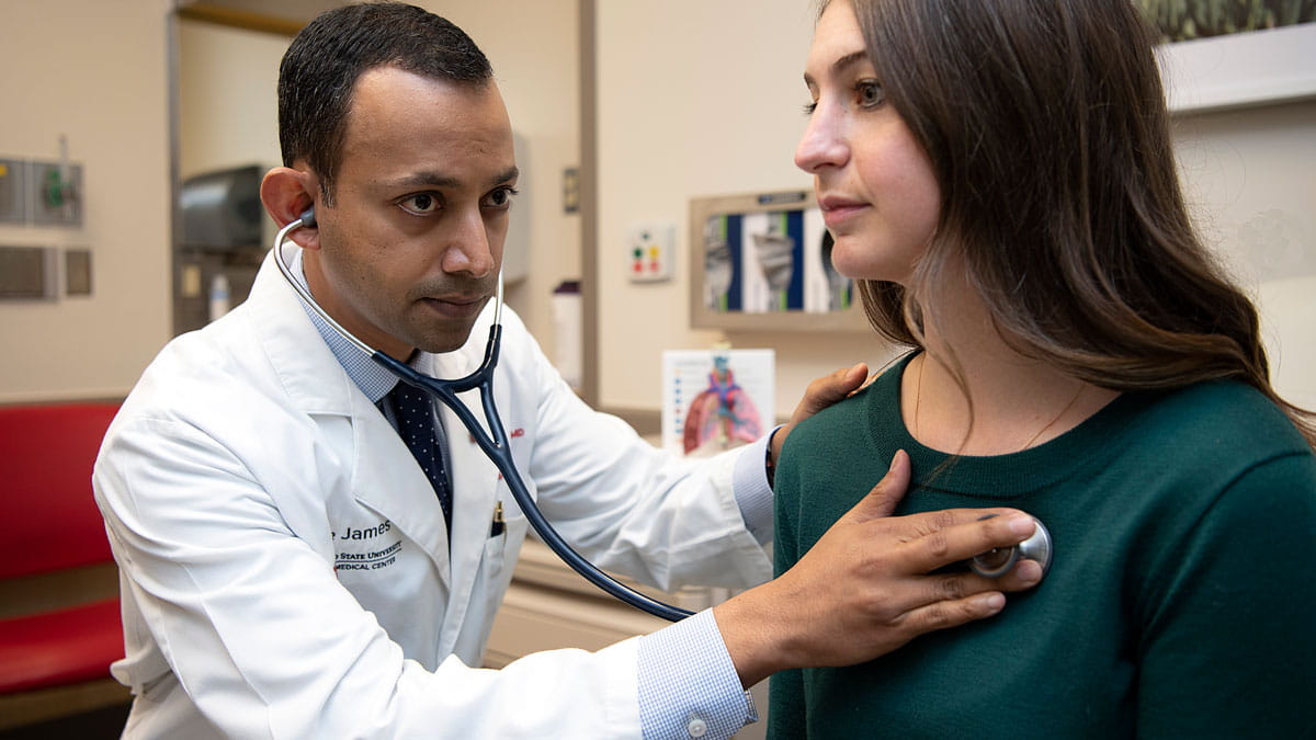 Doctor examining a patient using stethoscope