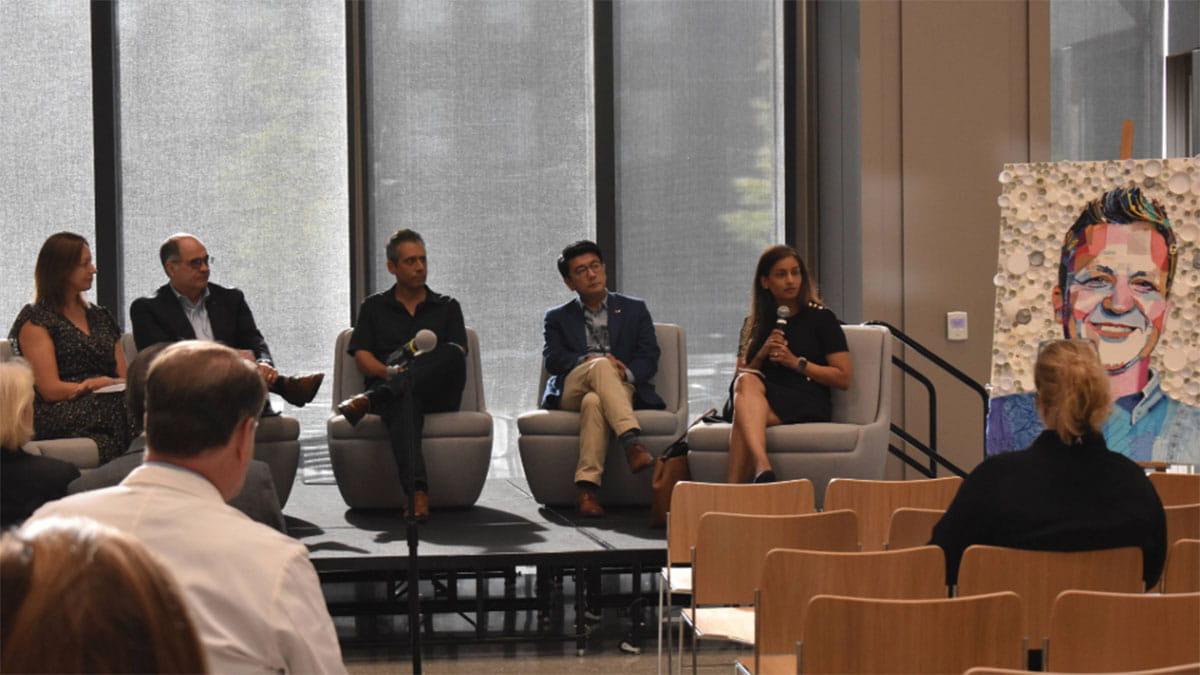 A group of people speaking on a panel