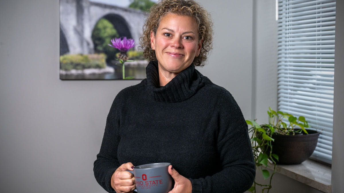 Image of Ashley Bertran holding a coffee cup