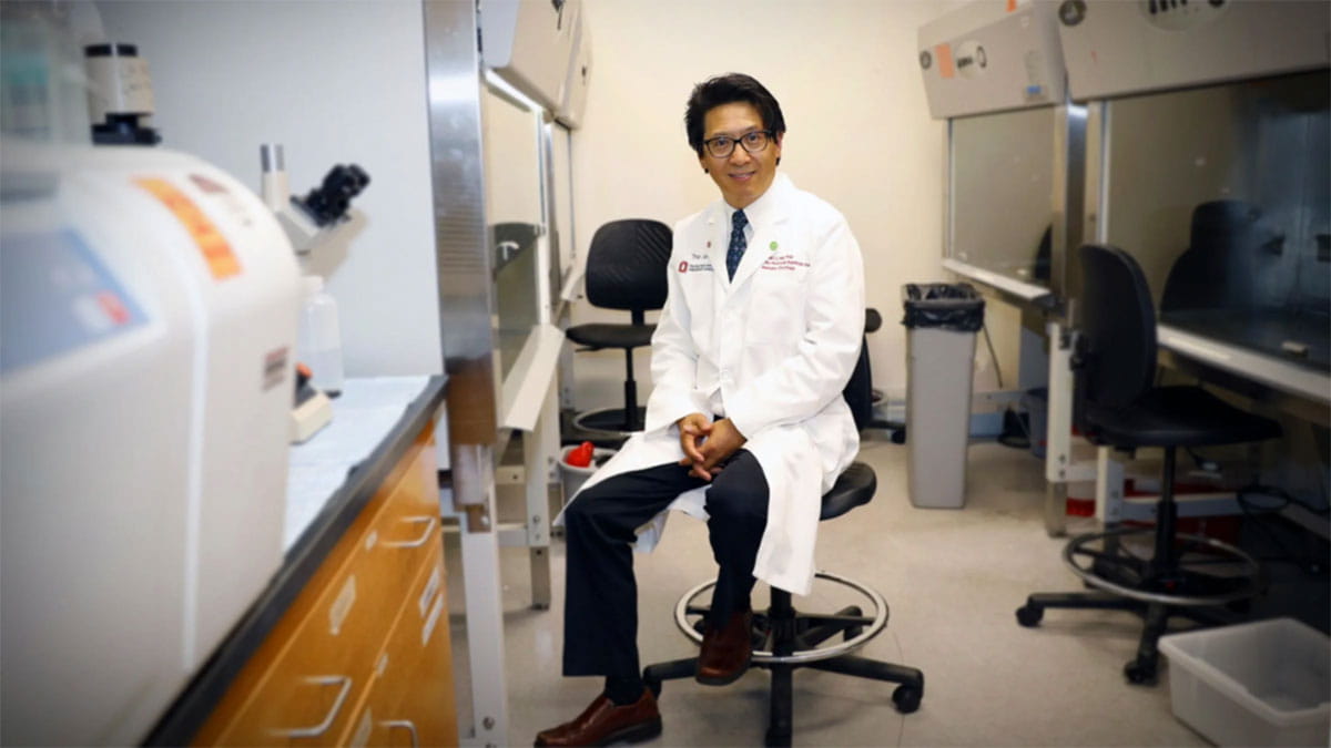 Image of Zihai Li sitting in a chair in a laboratory