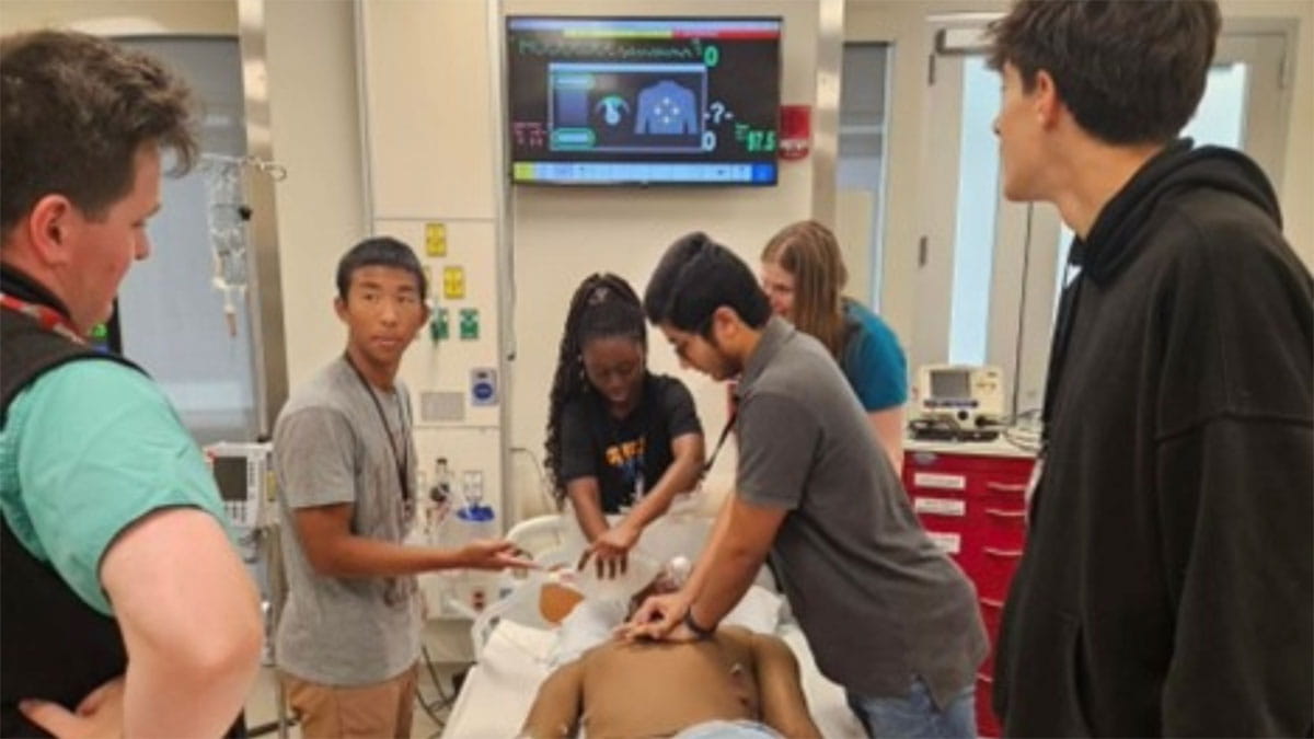 Students are instructed by general surgery resident physicians and run through a code blue simulation at the Clinical Skills Education and Assessment Center. 