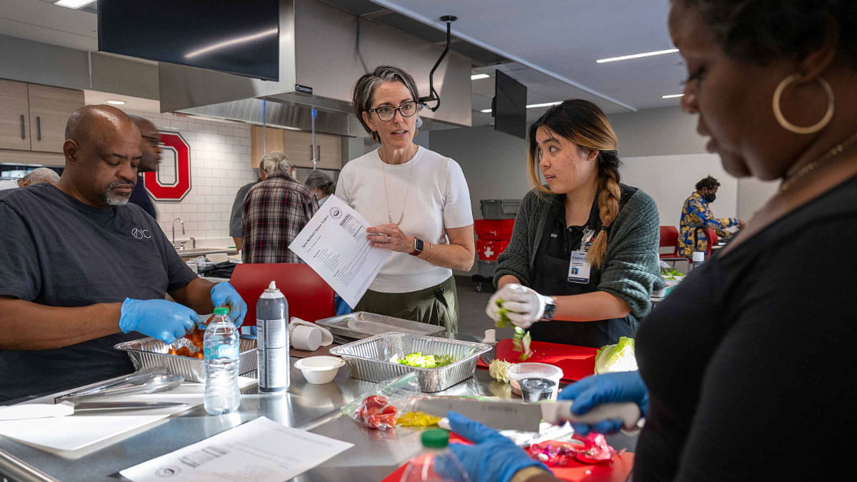 Four people preparing food.