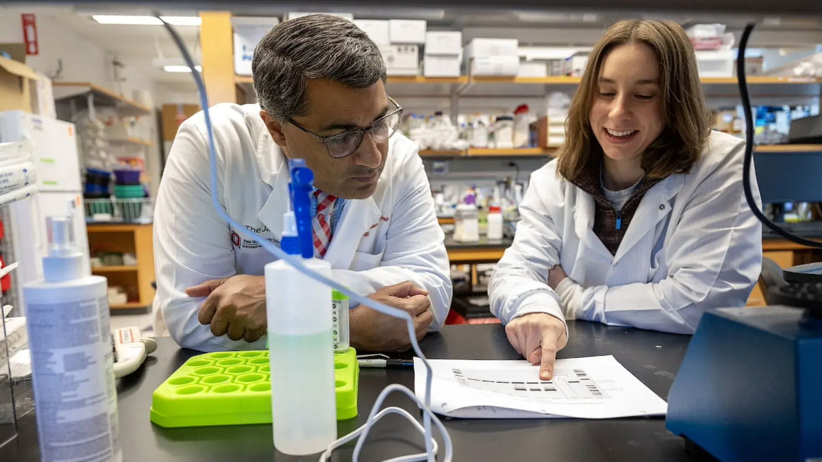 Two researchers review a document