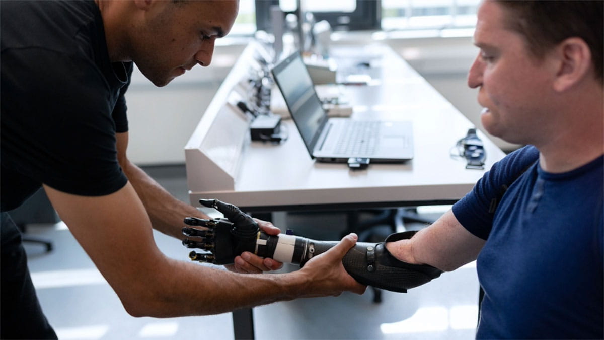 Image of a medical professional helping assist a person with a prosthetic arm.