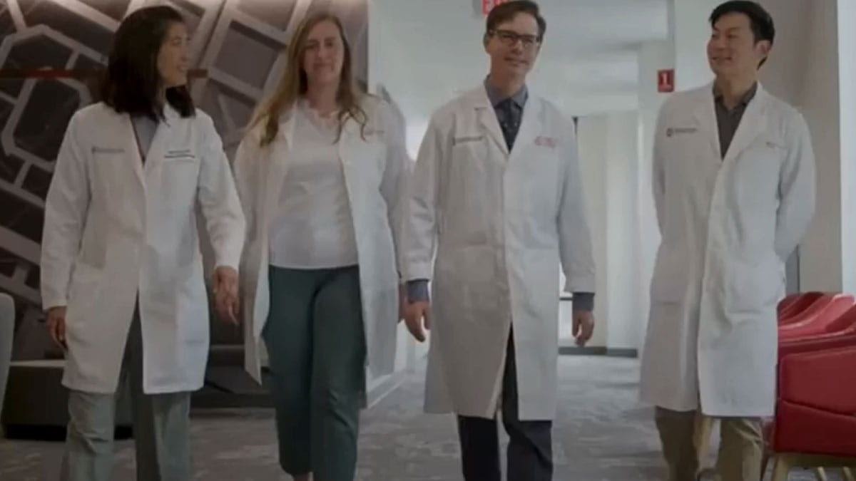 Image of four doctors walking together.