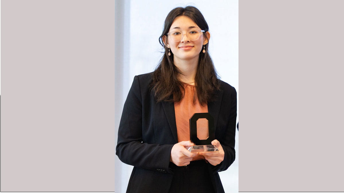 Image of Hannah Myers holding an award.