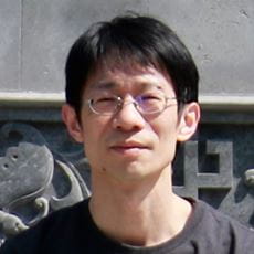 Headshot of Shaohong Feng with an Aztec temple relief as a background.