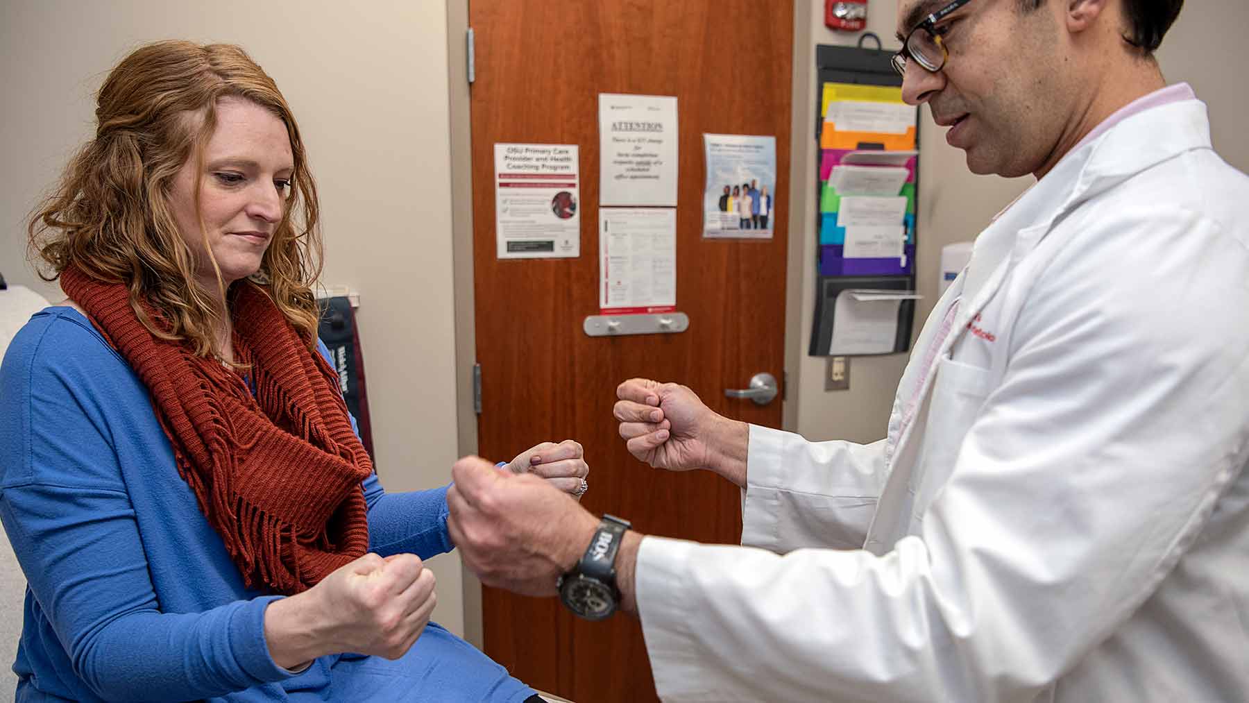 Dr. Ali Ajam examines a female patient who has lupus.
