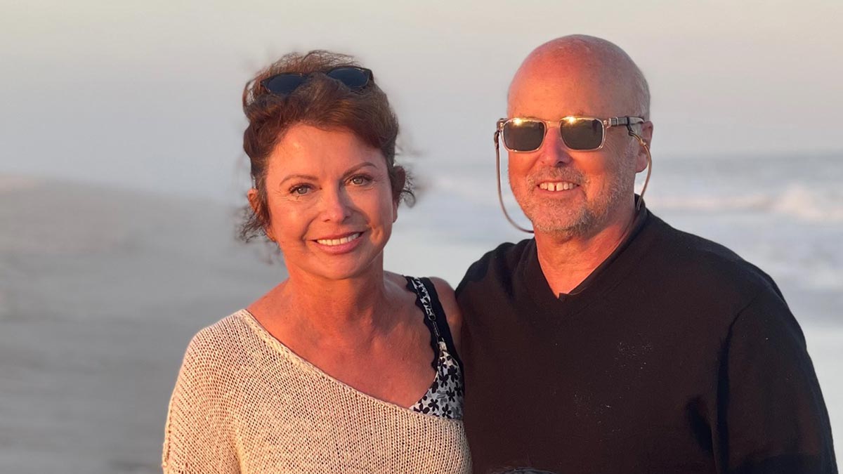 Patient and his wife on a beach