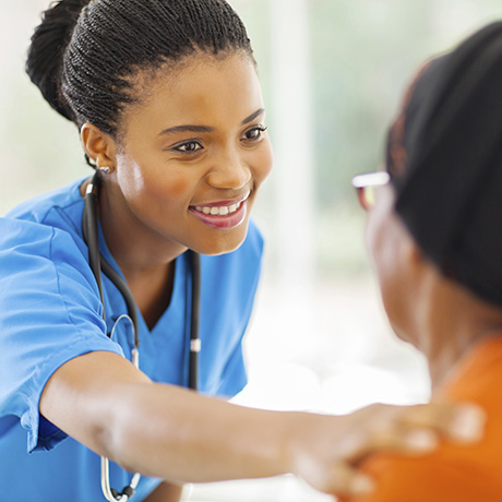 Healthcare provider with hand on woman’s shoulder